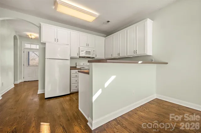 a view of a kitchen with wooden floor