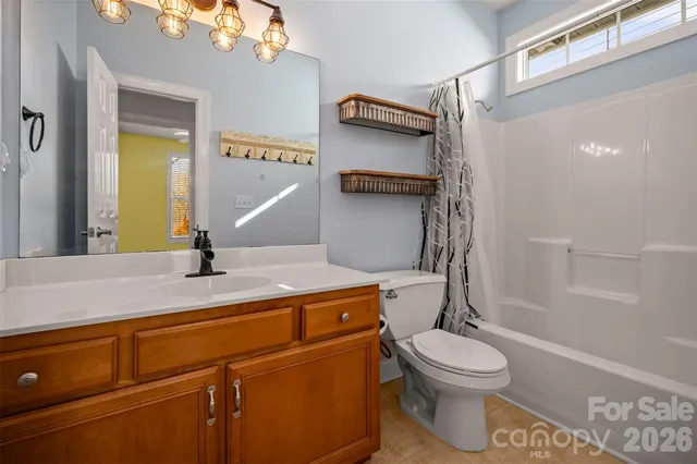 a bathroom with a toilet a sink and bathtub