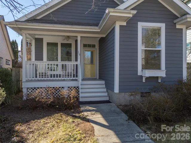 a view of a house with a small yard and wooden floor and fence