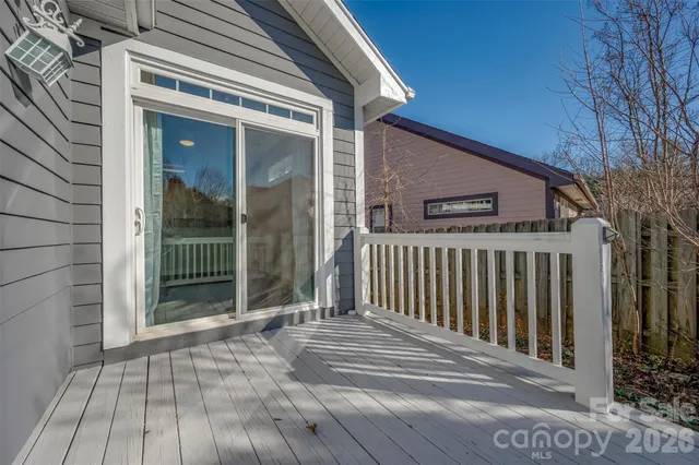 a view of a house with a wooden deck