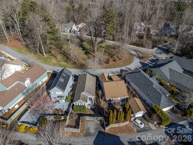 an aerial view of a house with a yard and lake view