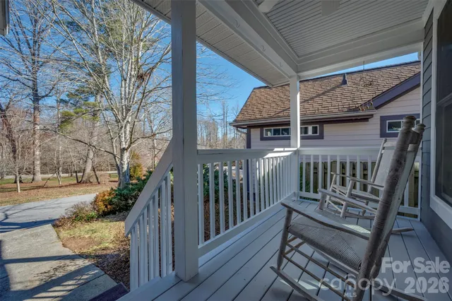 a view of a wooden chairs on the deck