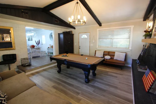 a living room with furniture a table and wooden floor