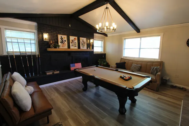 a living room with furniture a chandelier and a table