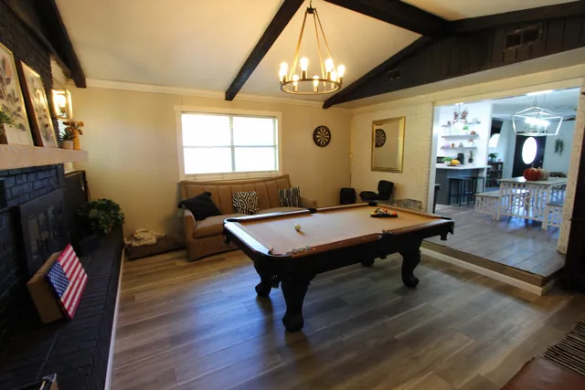 a living room with furniture a table and a large window