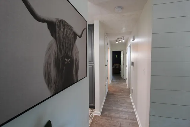 a view of a hallway with wooden shelves