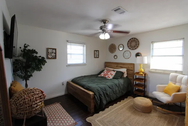 a bedroom with two beds and a chandelier