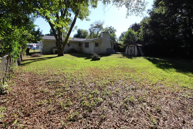 a view of a yard with large trees
