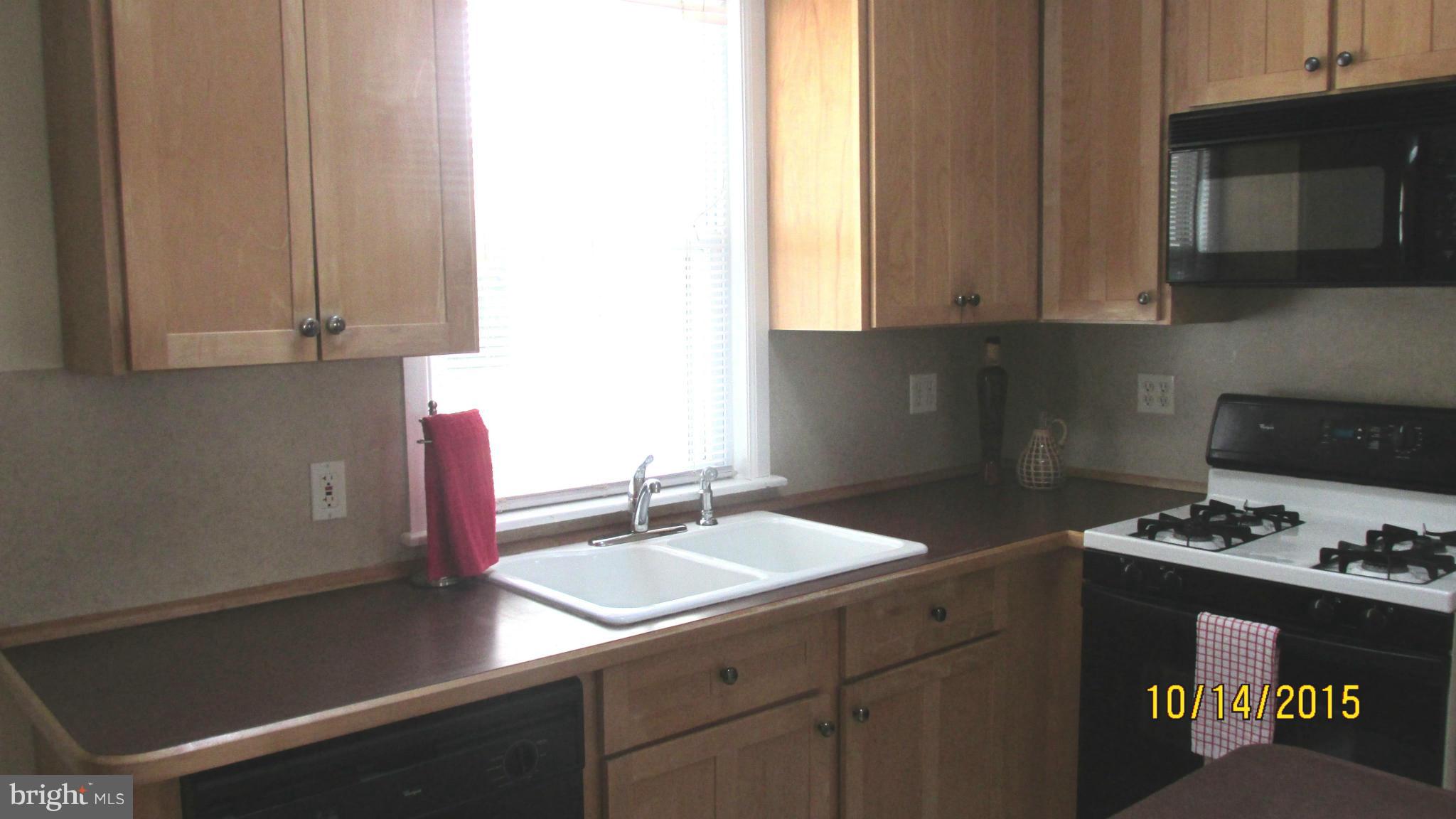 4108 Cliffvale Road Baltimore, MD 21236 - Photo 8 of 18 a kitchen with granite countertop a sink a stove and cabinets