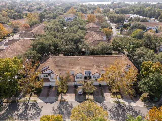 an aerial view of a house with a yard and lake view