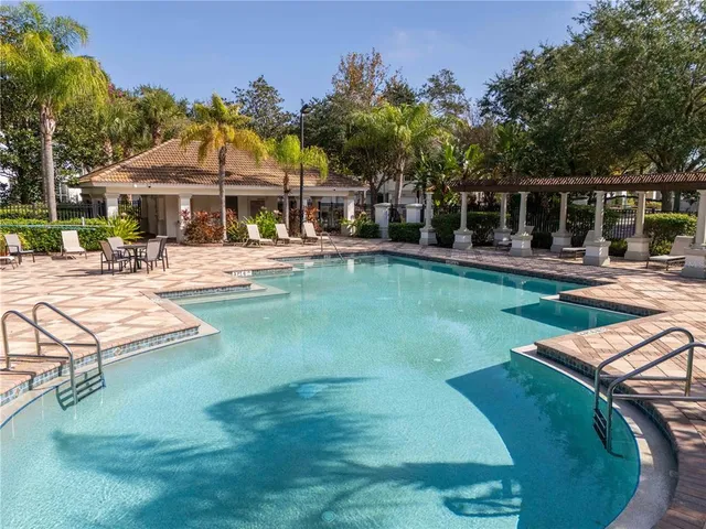 a view of a swimming pool with lounge chairs