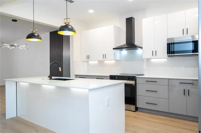 a kitchen with a stove and a wooden floor