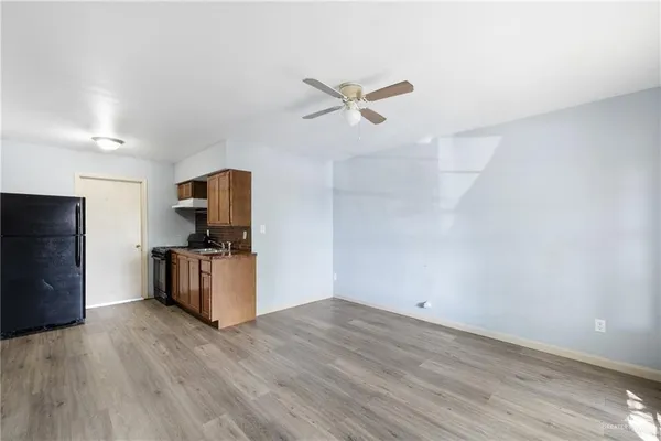 a view of kitchen with wooden floor and electronic appliances