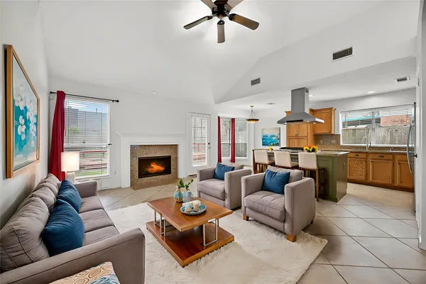 a living room with furniture kitchen view and a fireplace