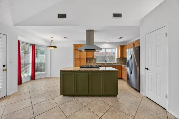 a kitchen with stainless steel appliances granite countertop a refrigerator and a sink