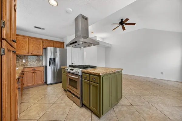 a kitchen with a stove and a refrigerator