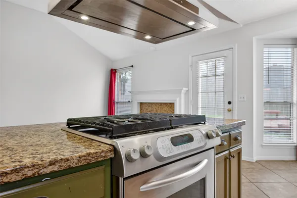 a stove top oven sitting inside of a kitchen