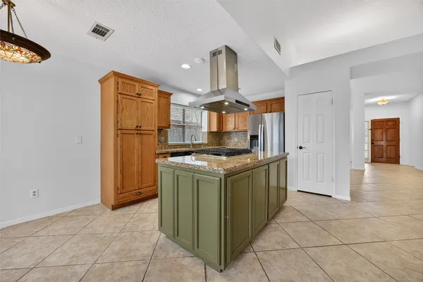a kitchen with a stove top oven and cabinets