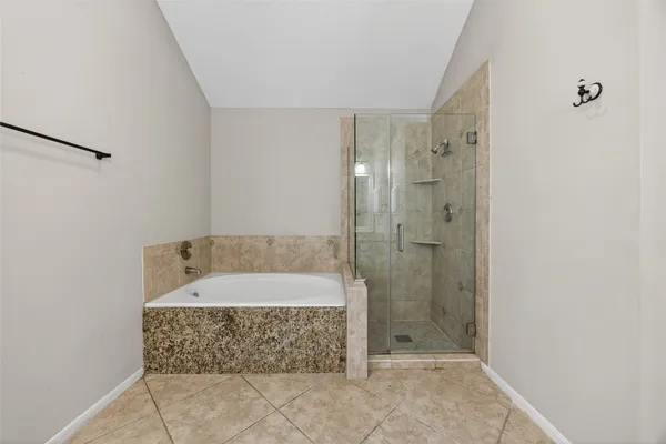 a bathroom with a bathtub and shower