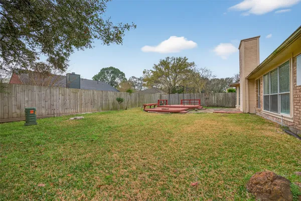 a house view with swimming pool and wooden fence