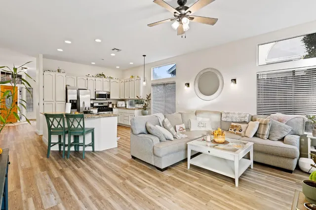 a living room with furniture and kitchen view