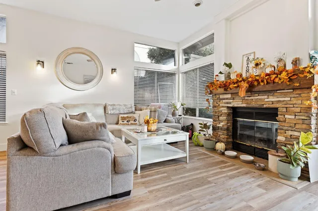a living room with furniture a fireplace and decor