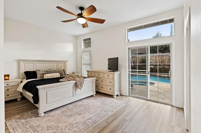 a bedroom with furniture and a flat screen tv