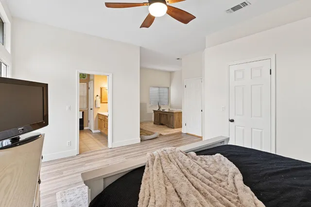 a bedroom with a bed and a flat screen tv