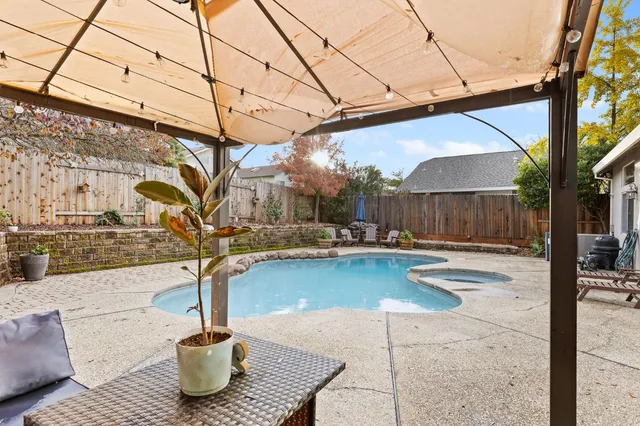 a view of a swimming pool with a patio