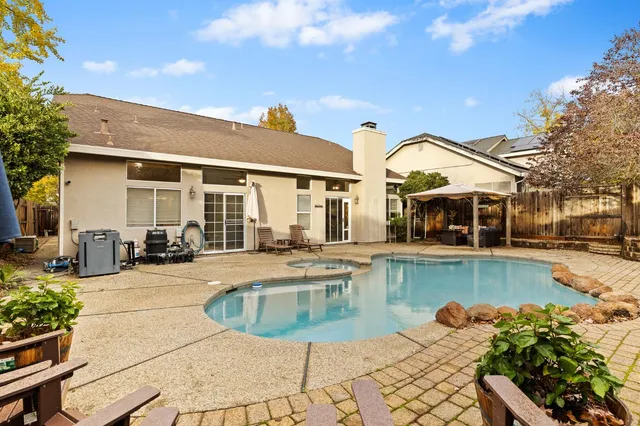 a view of a patio with swimming pool table and chairs