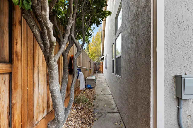 a backyard of a house with table and chairs