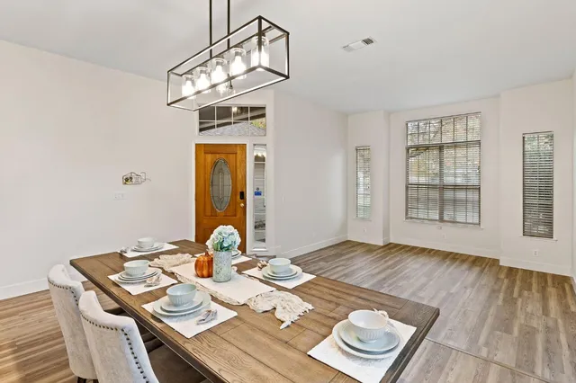 a view of a dining room with a table and chairs