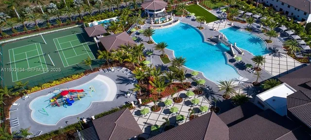 a swimming pool view with a seating space and a garden view