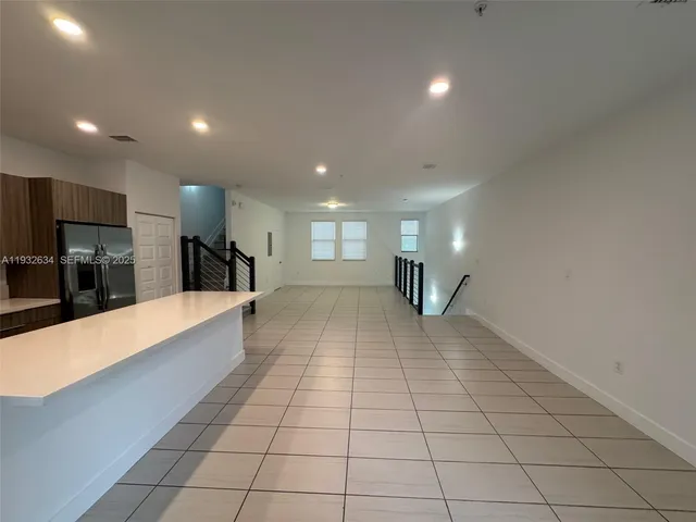 a large hall with stainless steel appliances lots of counter top space