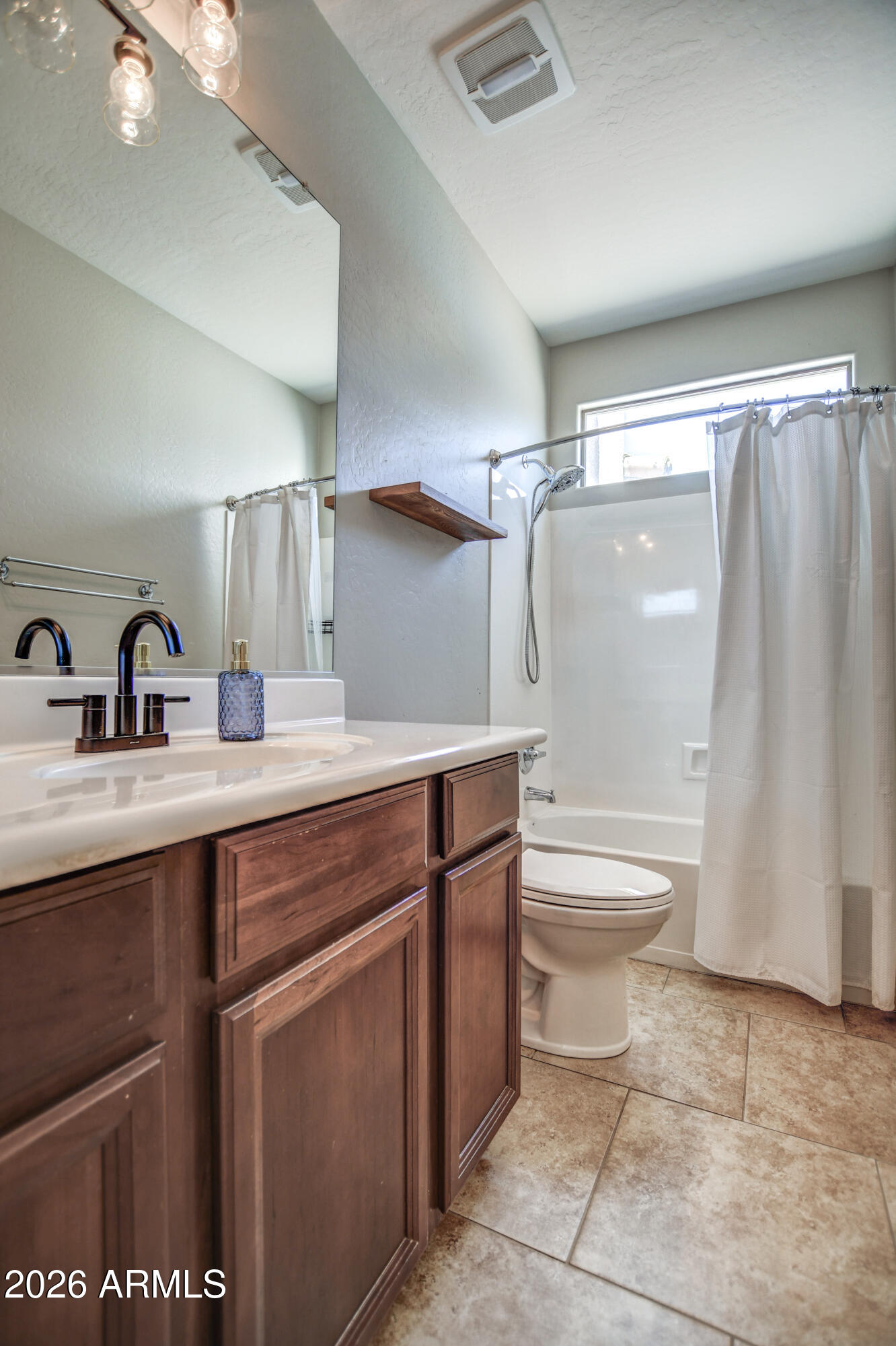 3078 East Muirfield Street Gilbert, AZ 85298 - Photo 51 of 92 a bathroom with a sink a toilet and shower
