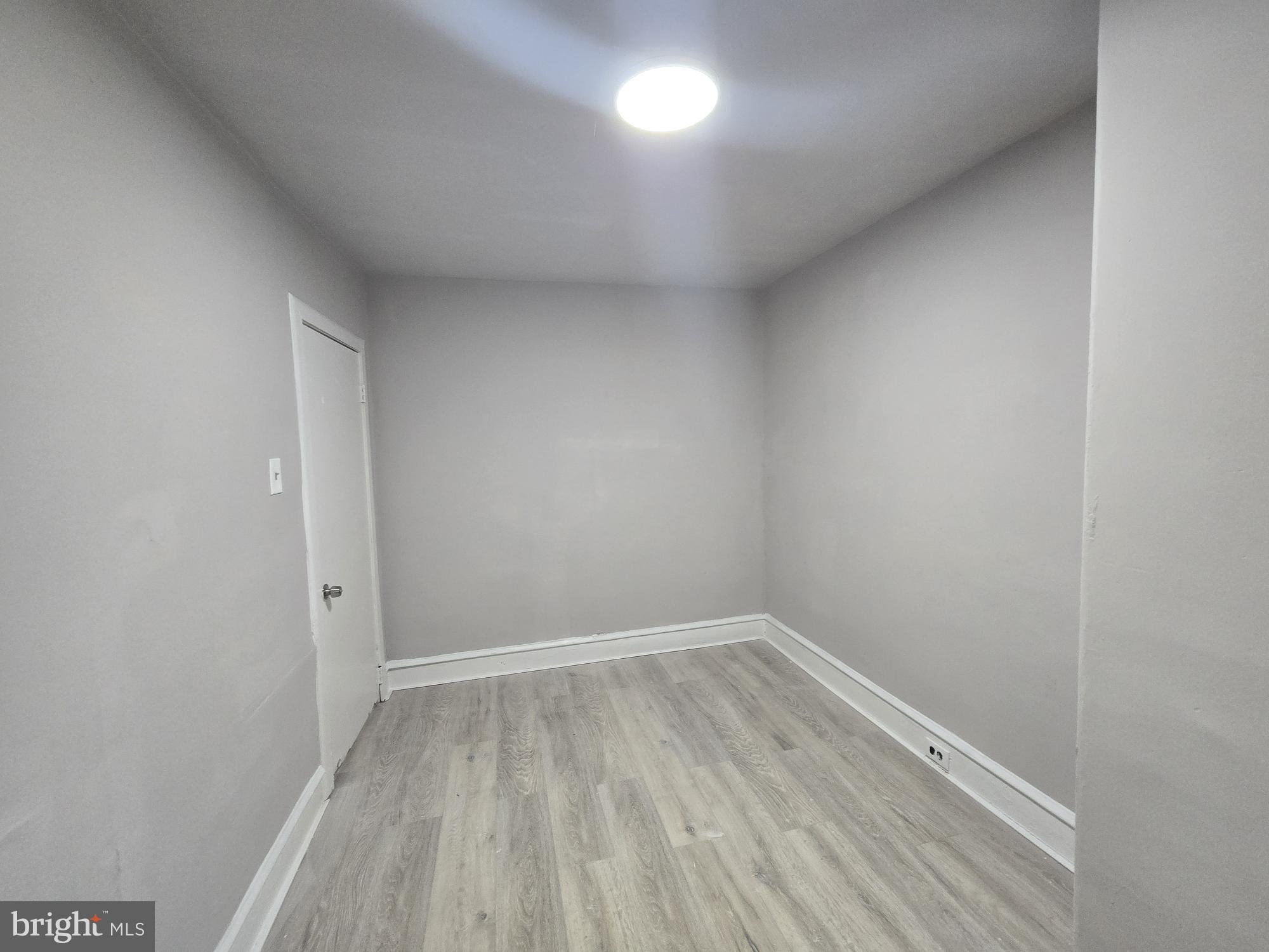 2642 South 67th Street Philadelphia, PA 19142 - Photo 11 of 23 an empty room with wooden floor and natural light