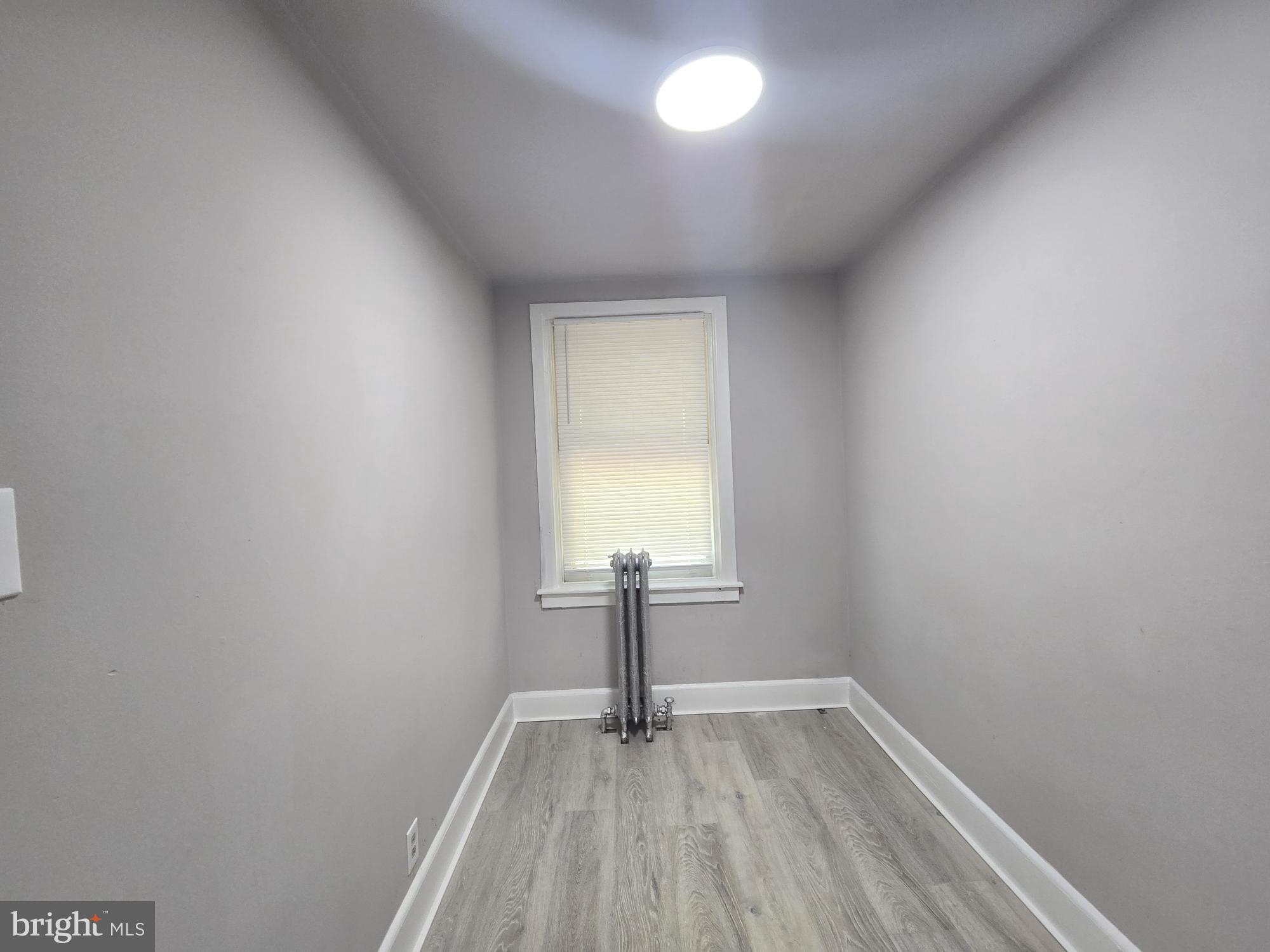 2642 South 67th Street Philadelphia, PA 19142 - Photo 13 of 23 a view of empty room with window and wooden floor