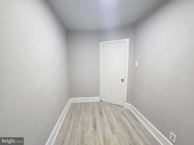 a view of a room with wooden floor