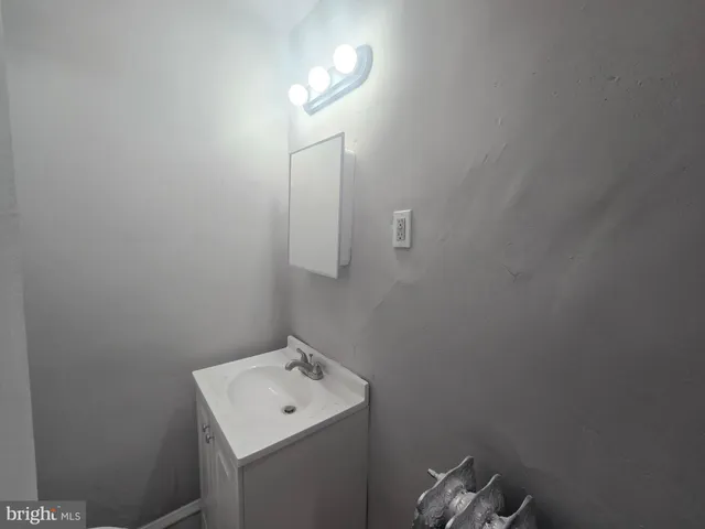 a bathroom with a sink toilet and mirror
