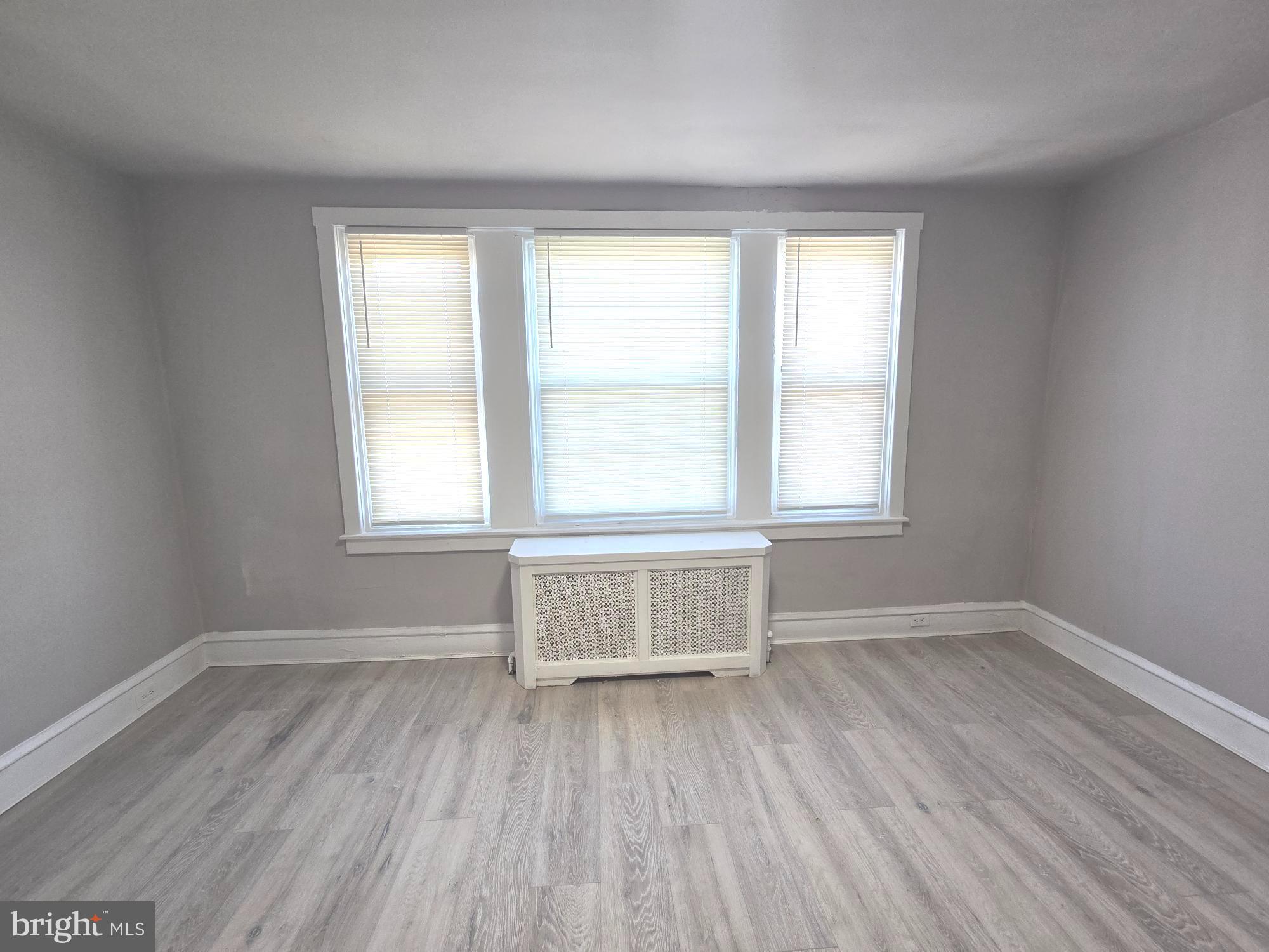 2642 South 67th Street Philadelphia, PA 19142 - Photo 19 of 23 an empty room with wooden floor and windows