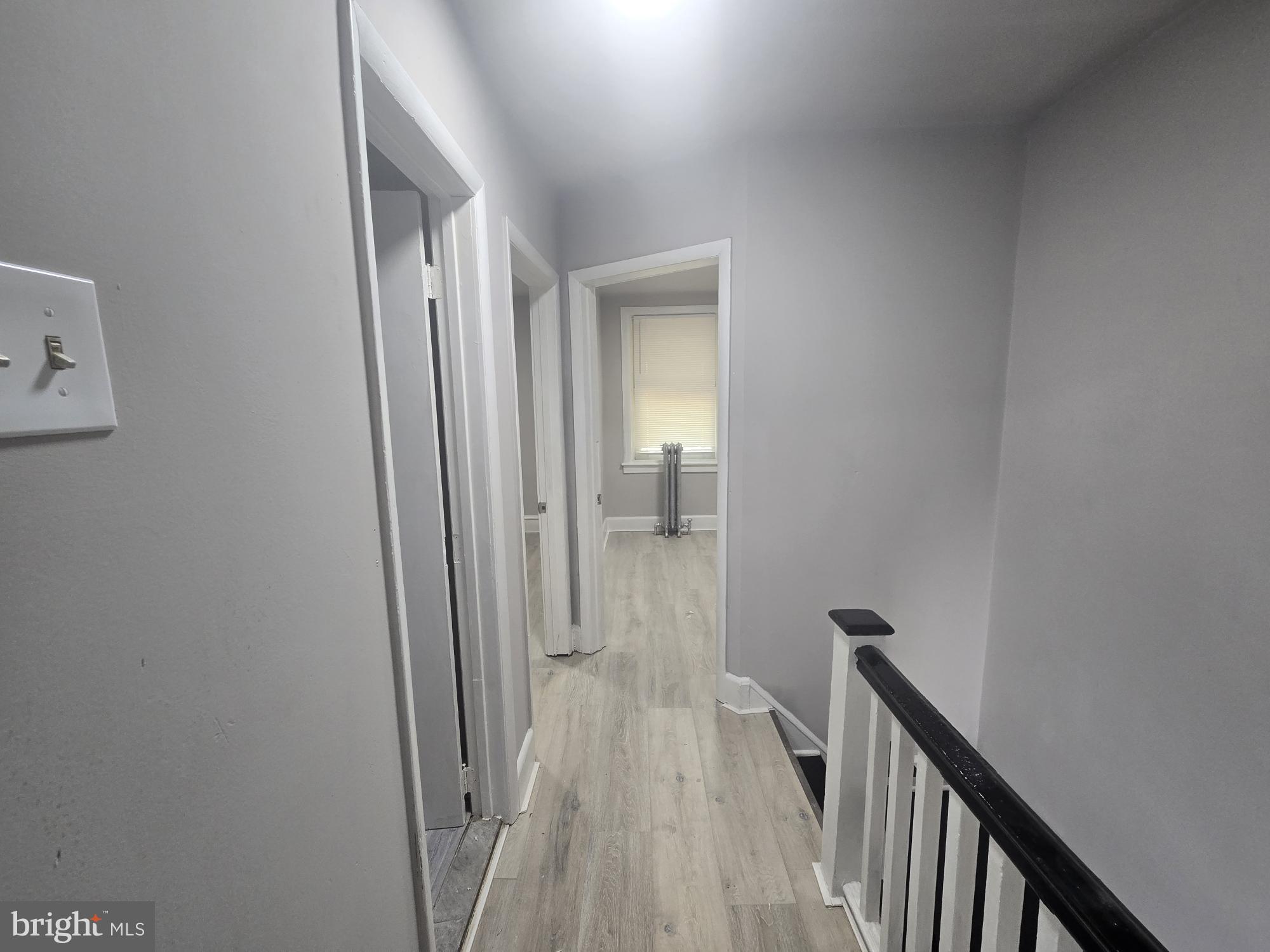 2642 South 67th Street Philadelphia, PA 19142 - Photo 22 of 23 a view of a hallway with wooden floor and staircase