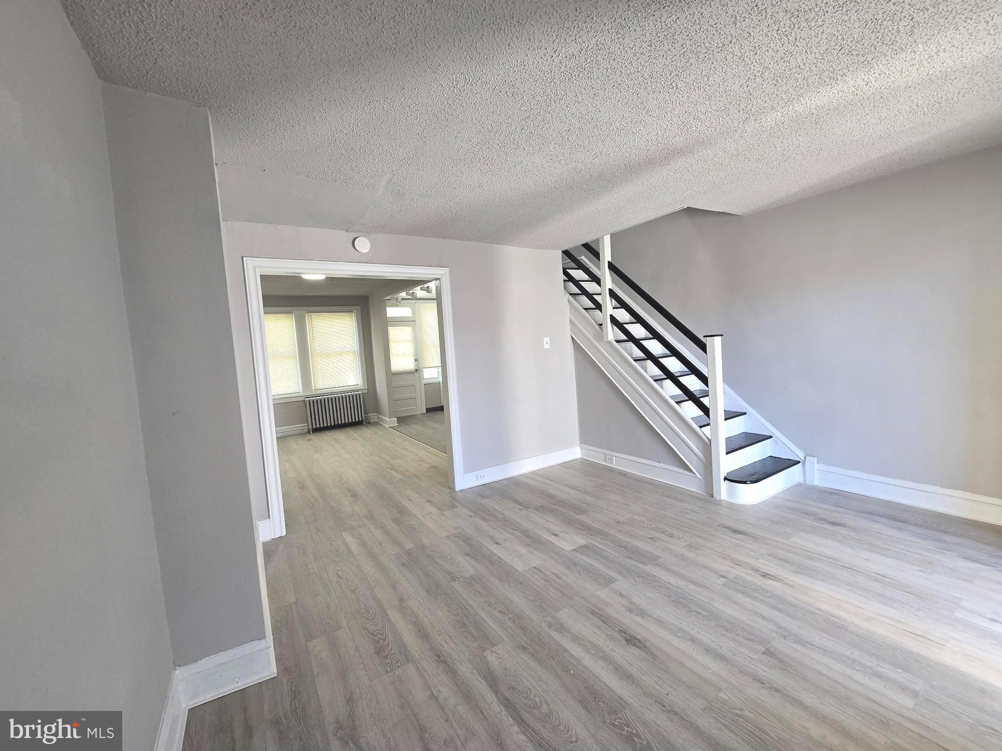 2642 South 67th Street Philadelphia, PA 19142 - Photo 3 of 23 an empty room with wooden floor and entryway