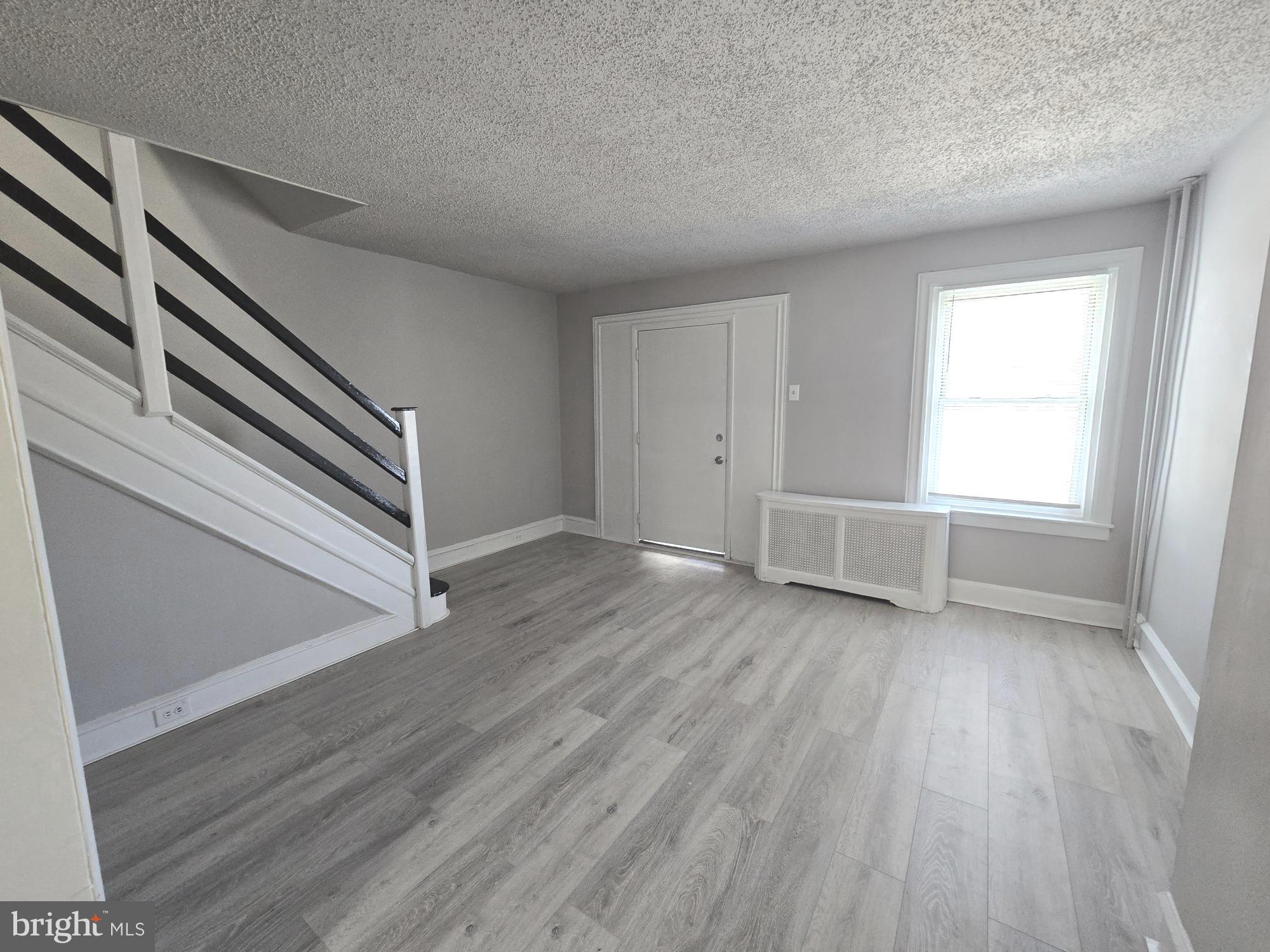 2642 South 67th Street Philadelphia, PA 19142 - Photo 4 of 23 a view of an empty room with wooden floor and a window