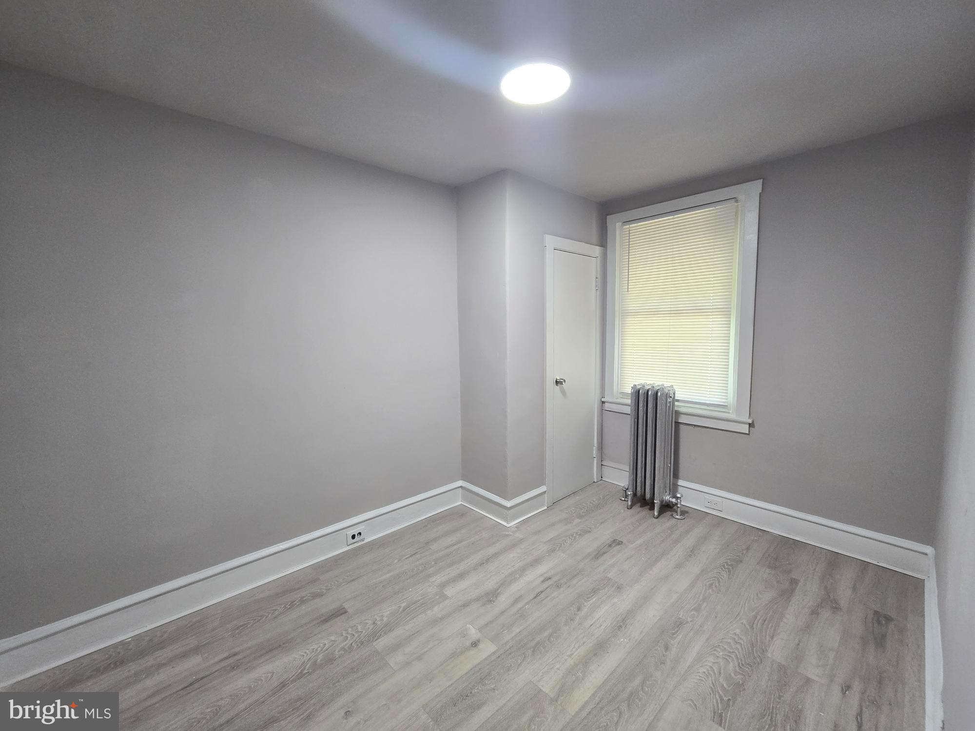 2642 South 67th Street Philadelphia, PA 19142 - Photo 9 of 23 an empty room with wooden floor and windows