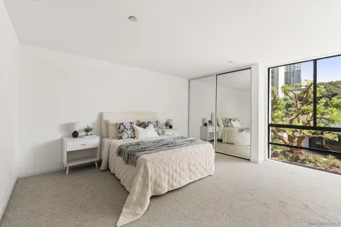 a spacious bedroom with a bed and a large window
