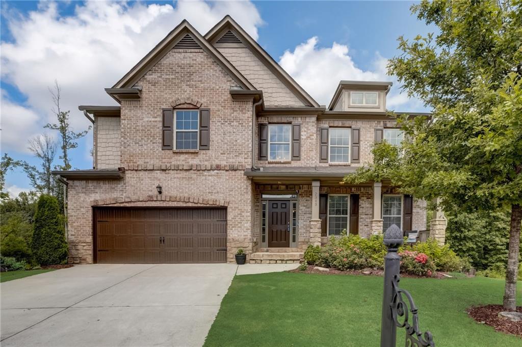a front view of a house with a garden and plants