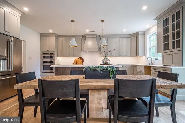 a kitchen with kitchen island granite countertop a sink stove and refrigerator