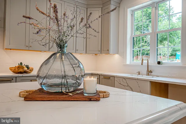 a kitchen with a table chairs refrigerator and cabinets