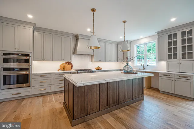 a kitchen with stainless steel appliances granite countertop a sink stove and cabinets