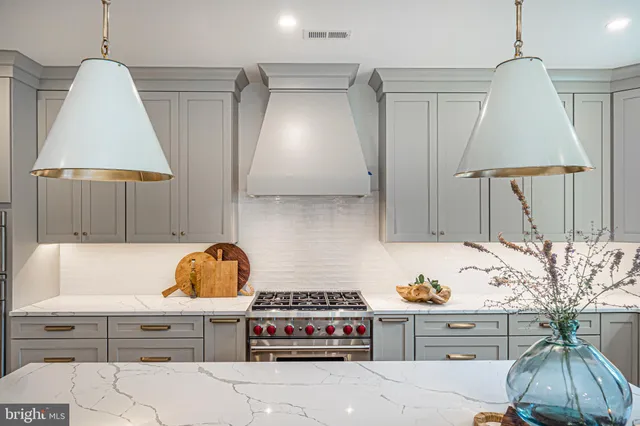 a stove top oven sitting inside of a kitchen